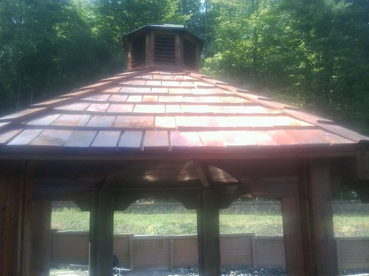 New cedar shake roof and cupola on a lakeside gazebo in Carleton